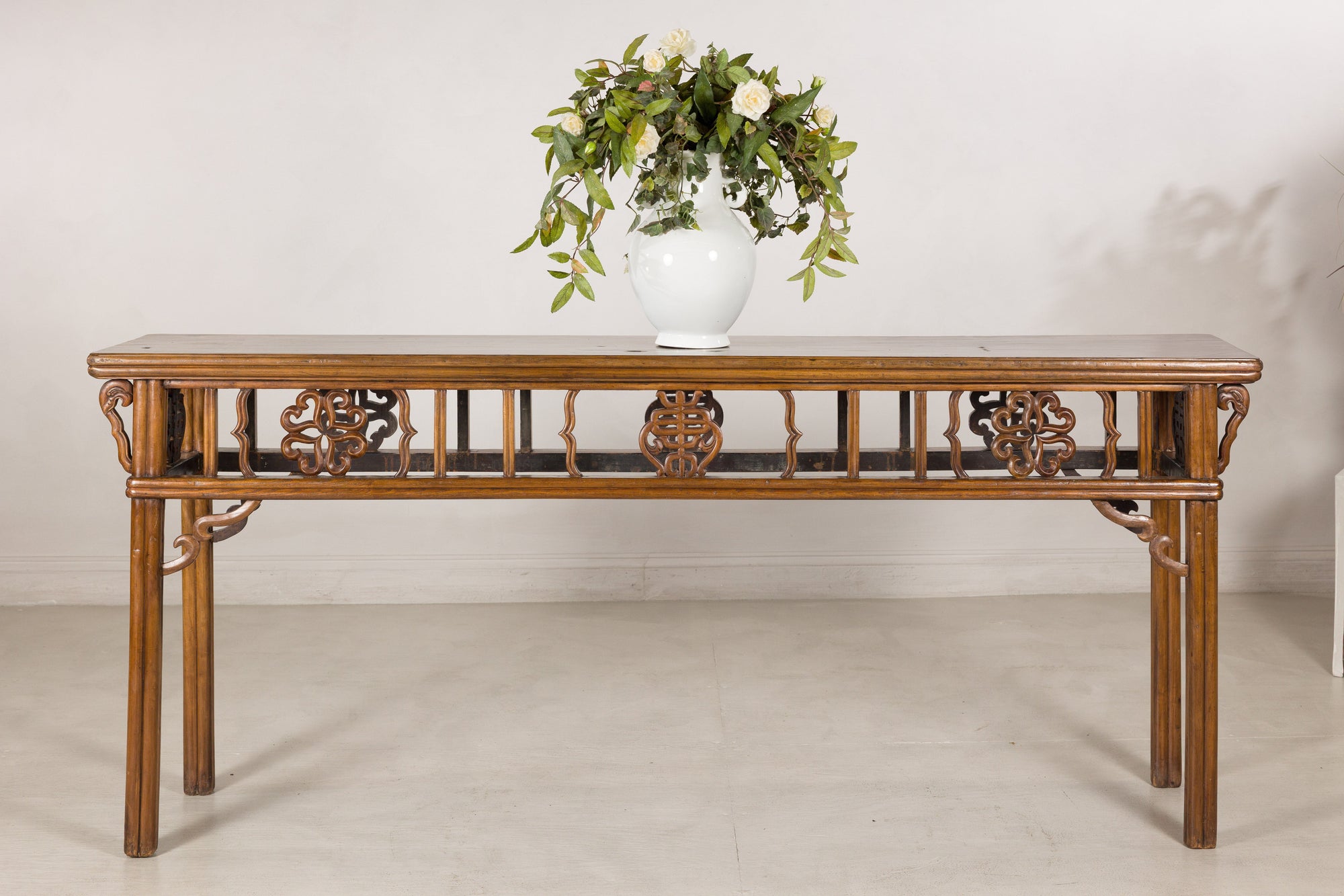 Long antique Chinese console table styled with a white vase