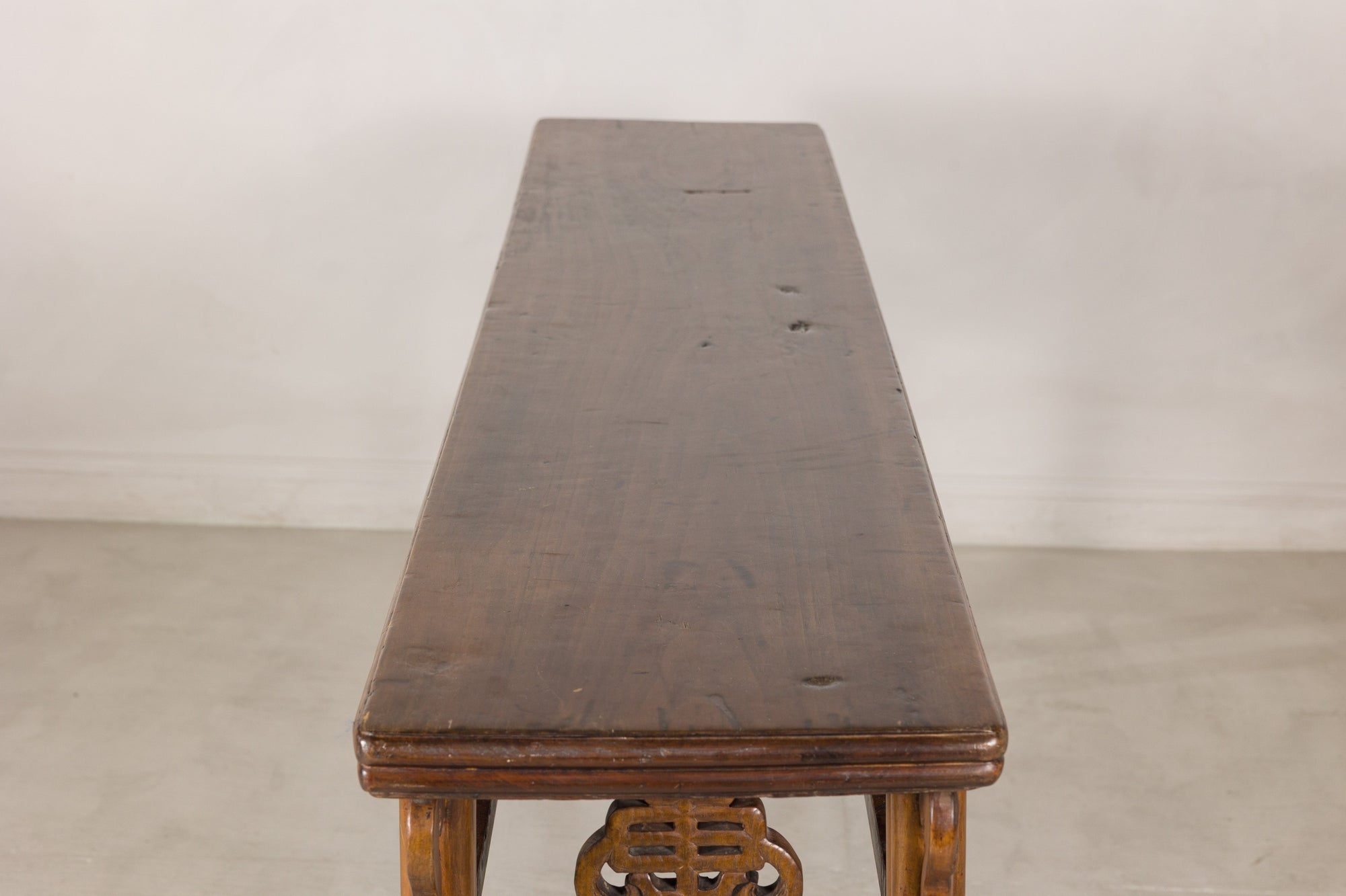 Lengthwise view of the narrow plank top on the Chinese console table