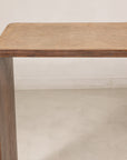 Close-up of the waterfall edge where the rattan top meets dark wood