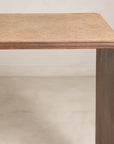 Close-up of the rounded wood corner and woven rattan top