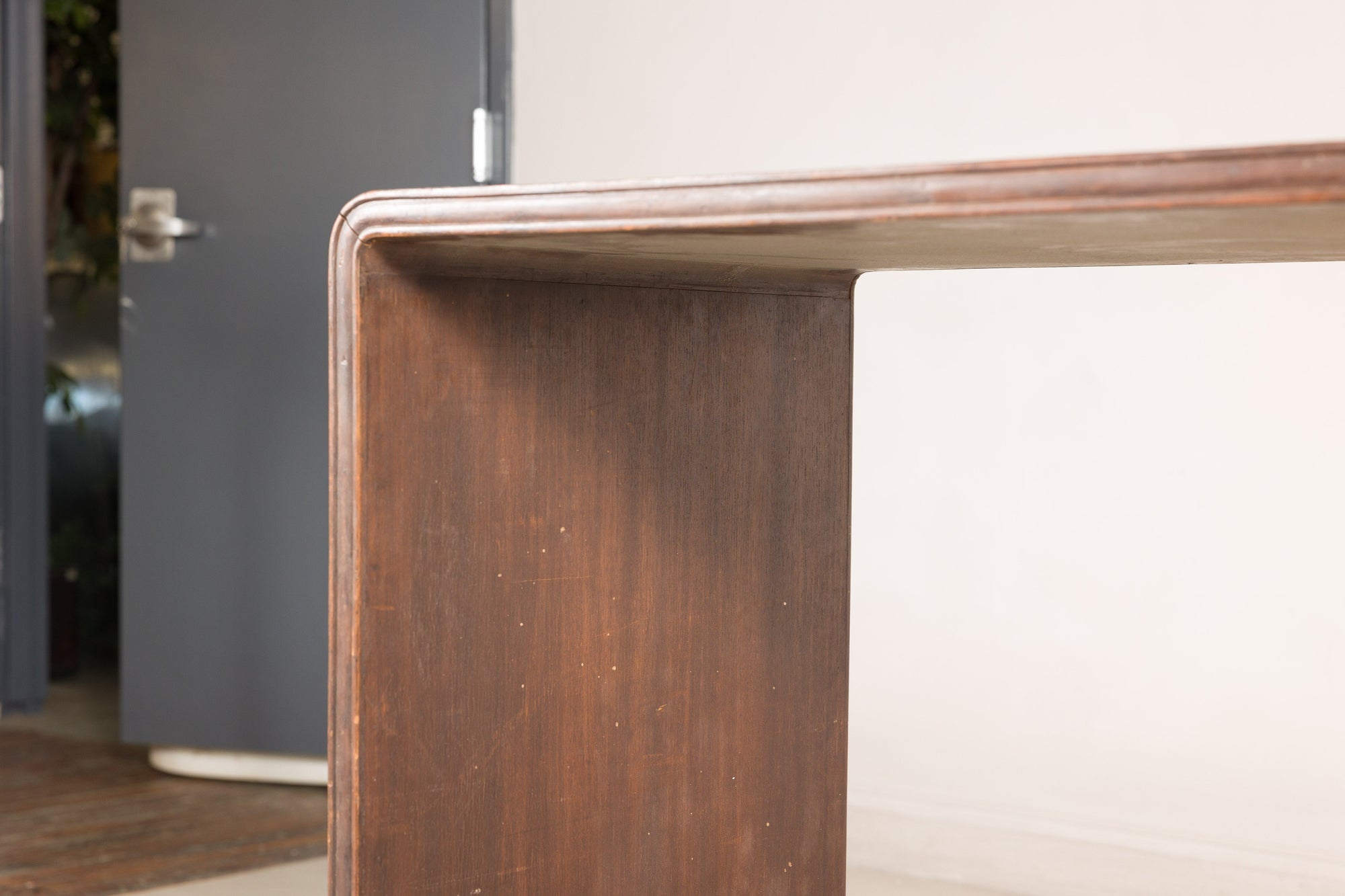 Close-up of the wood grain and rounded edge on the console table