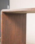Close-up of the wood grain and rounded edge on the console table