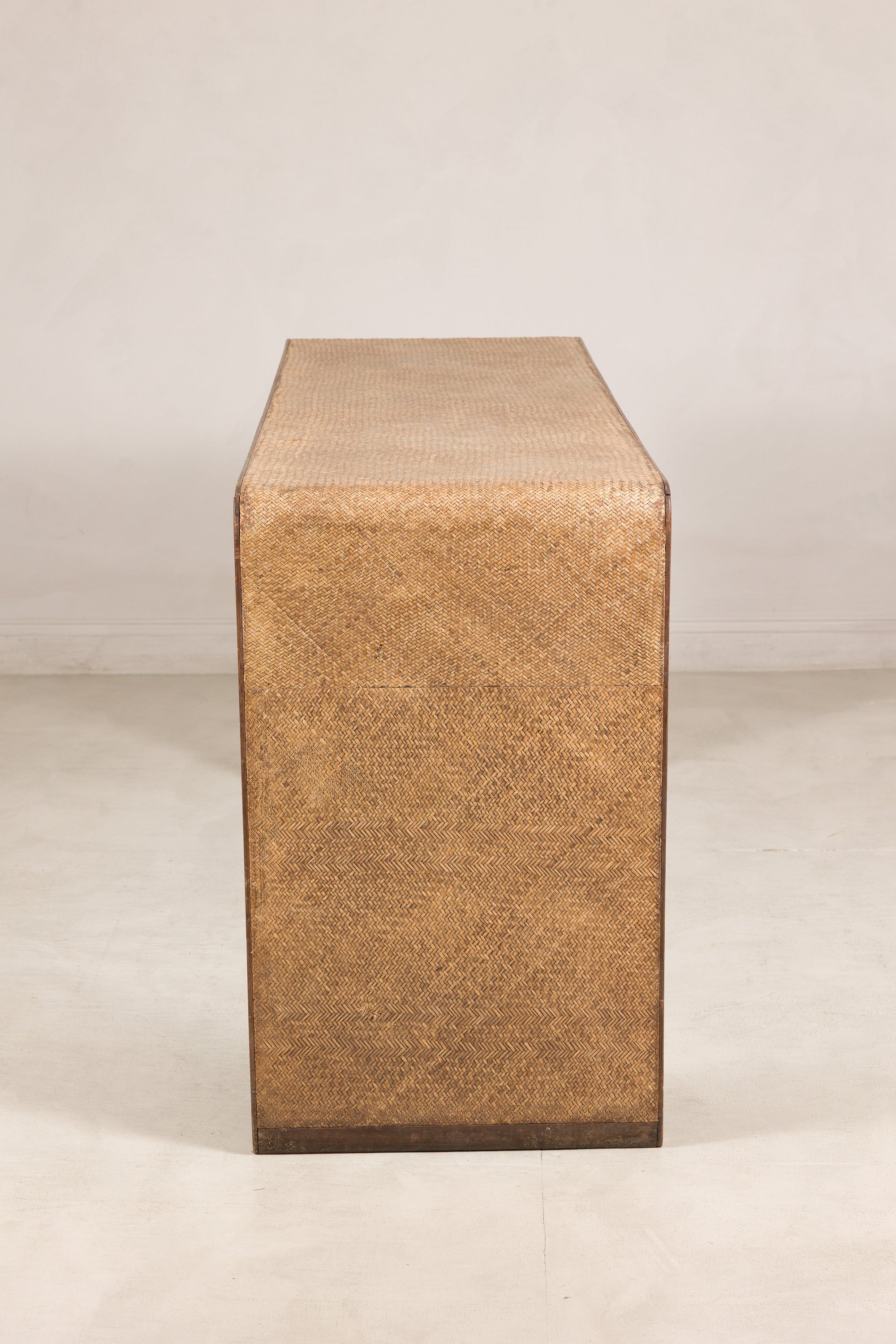 End profile of the narrow waterfall console with woven rattan panel