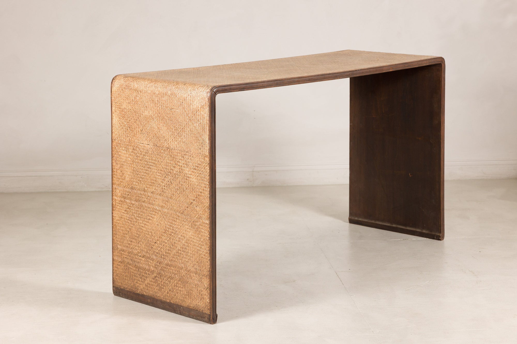 Left angled view of the woven rattan waterfall console