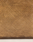 Close-up of a woven rattan end panel framed in dark wood