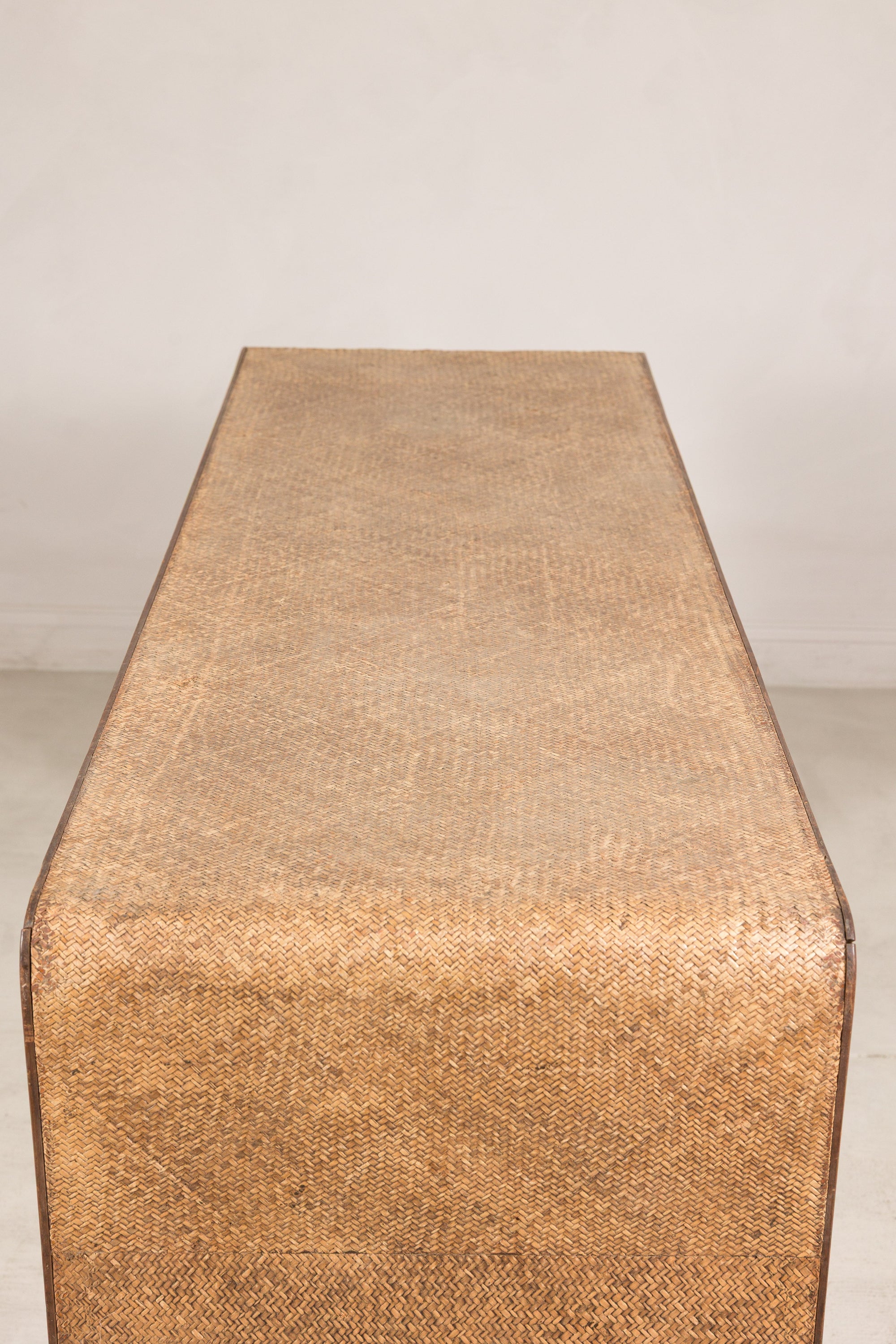 Close-up of the woven rattan tabletop and rounded waterfall edge