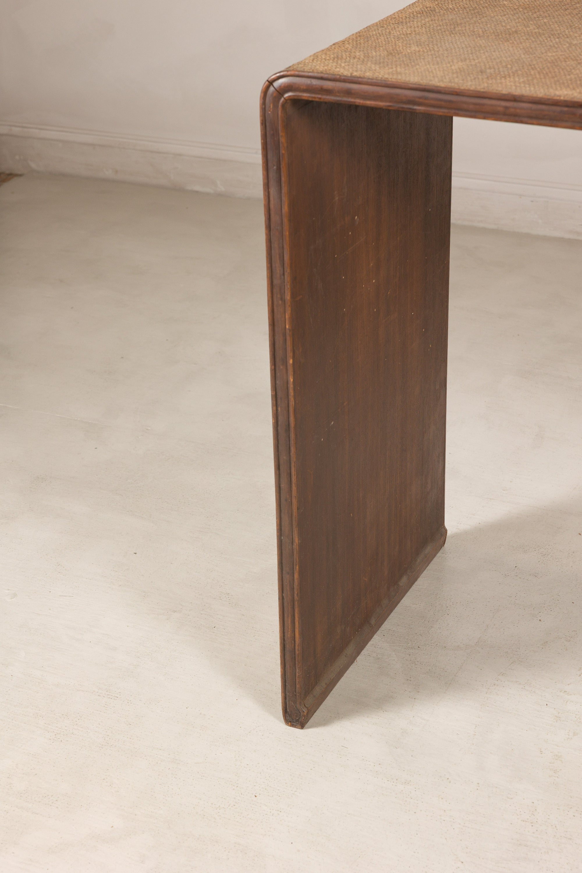 Close-up of a dark wood side panel and rounded top corner