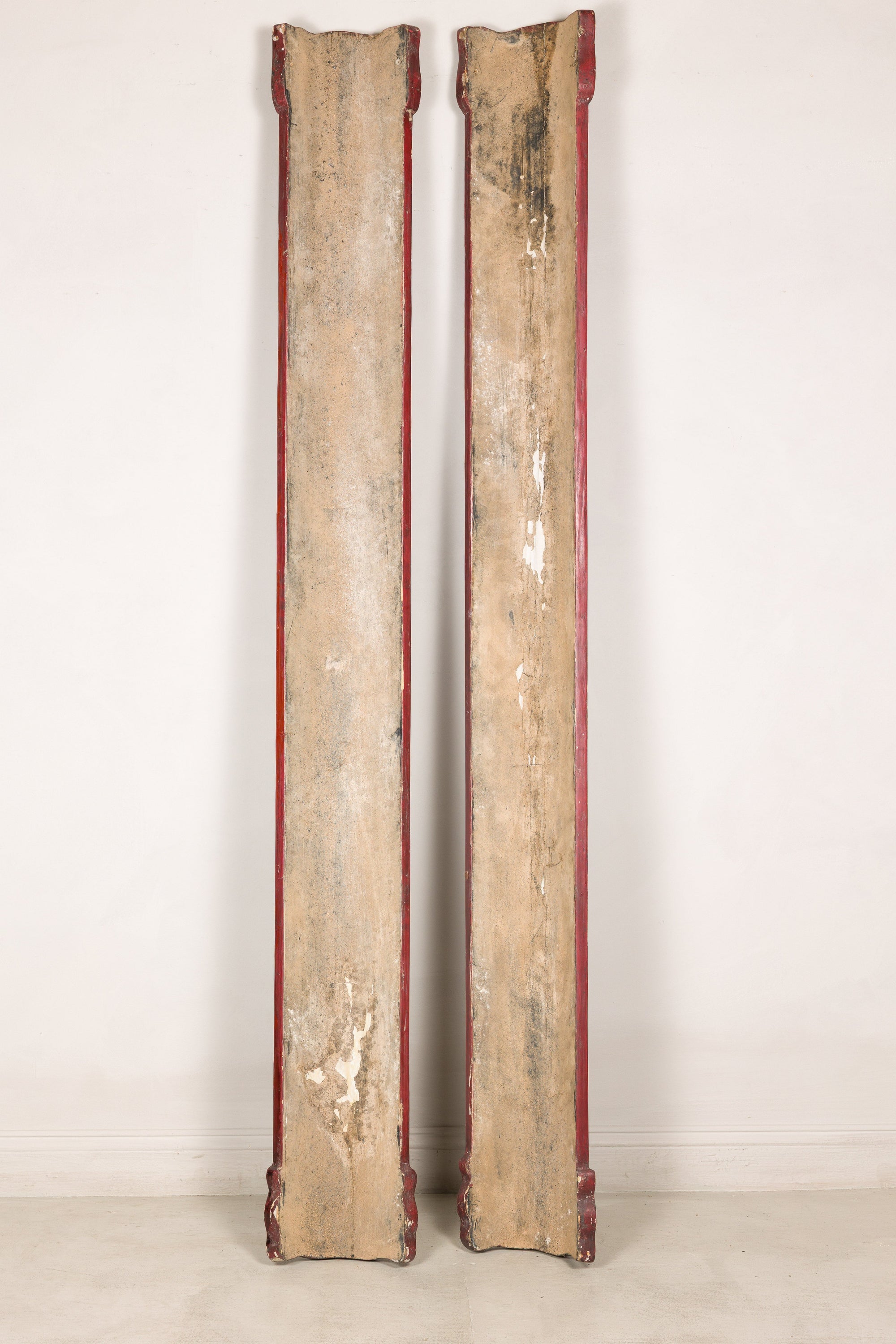 Detail of aged red finish and raised gilt characters on Chinese wood panels