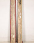 Detail of aged red finish and raised gilt characters on Chinese wood panels