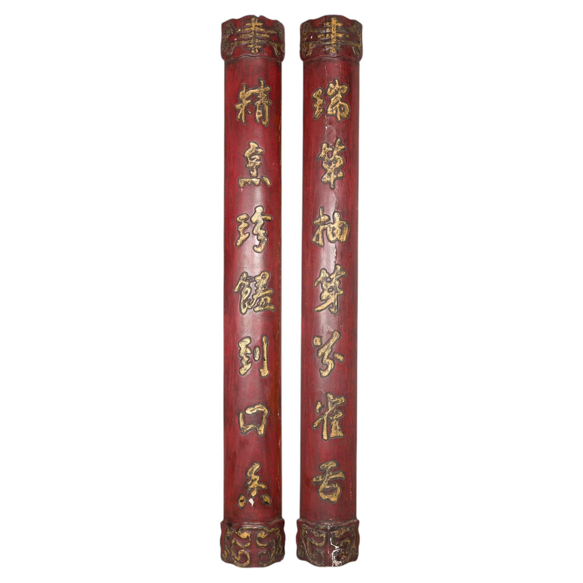 Red and gilt Chinese calligraphy panels on a white background