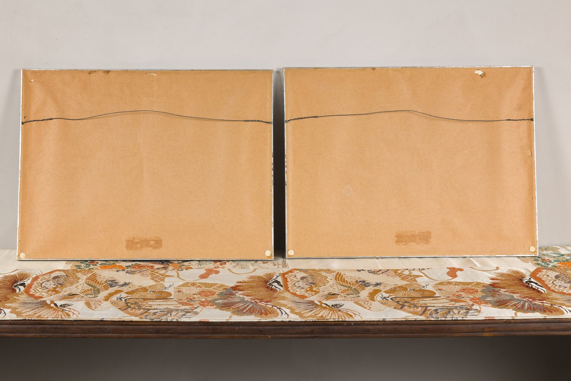 Back view of the paired Japanese woodblock prints in silvered frames