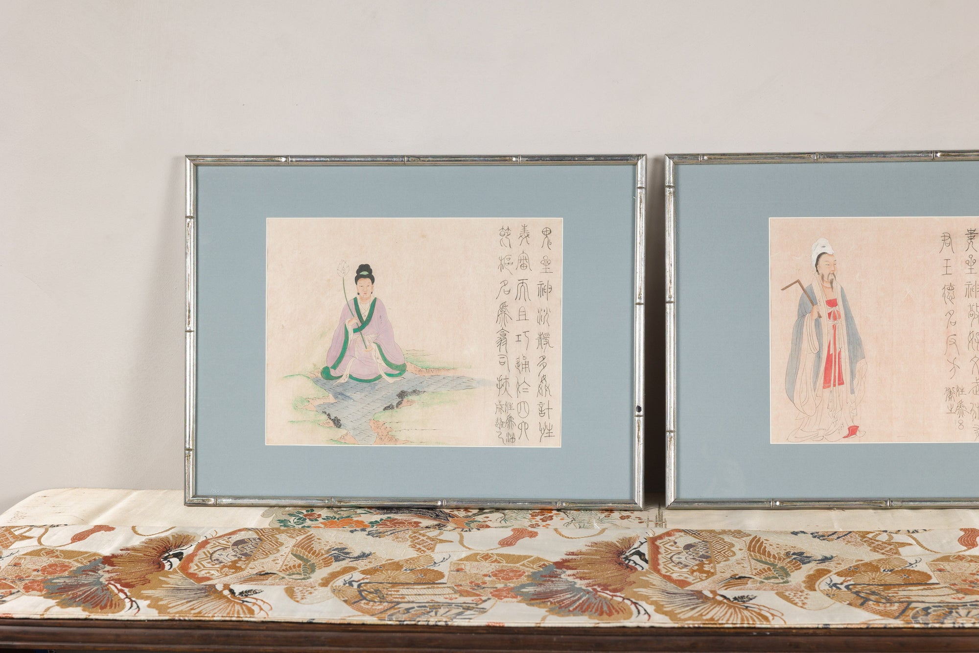 Close view of paired silvered frames and Japanese figure studies