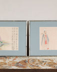 Pair of framed Japanese figural prints displayed on a patterned textile