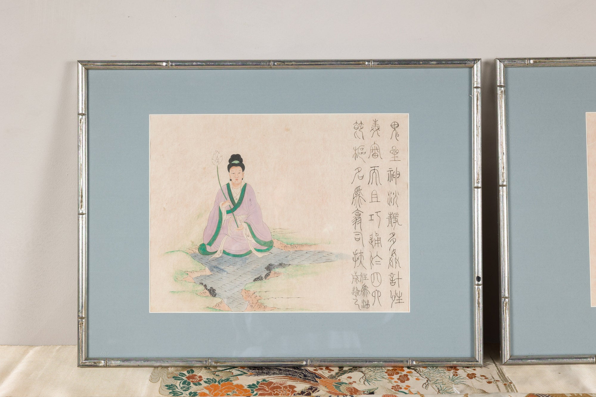 Framed Japanese print of a seated figure with calligraphy