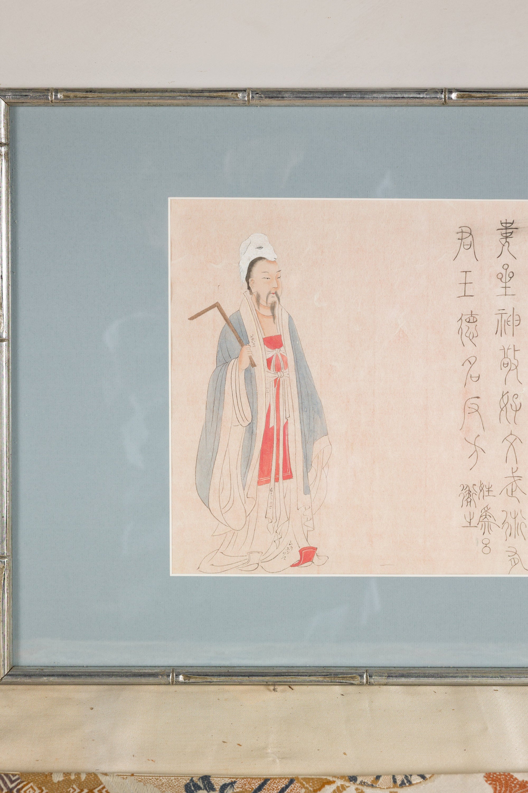 Close-up of the standing Japanese figure and vertical inscription