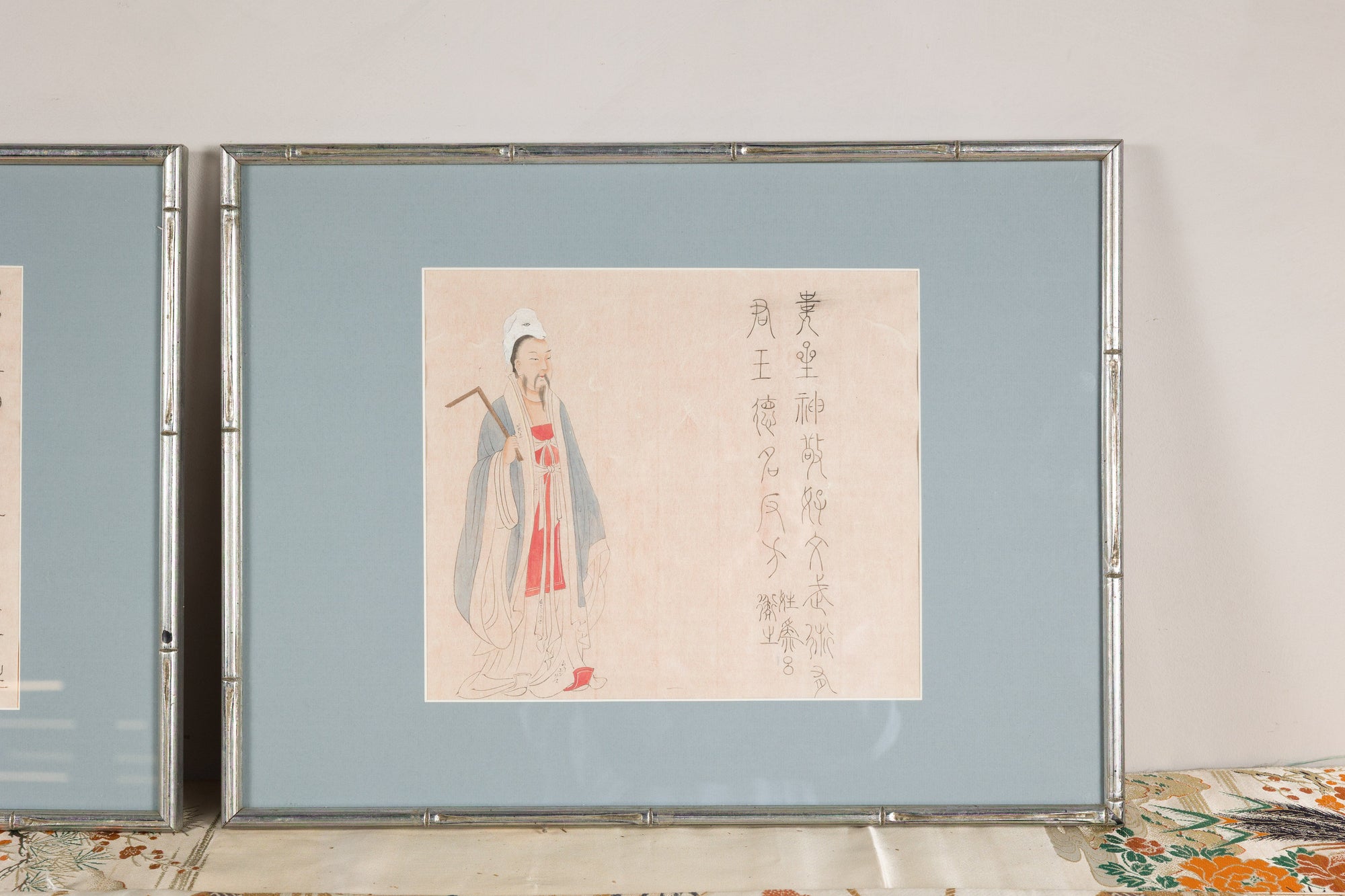 Framed Japanese print of a standing figure with calligraphy