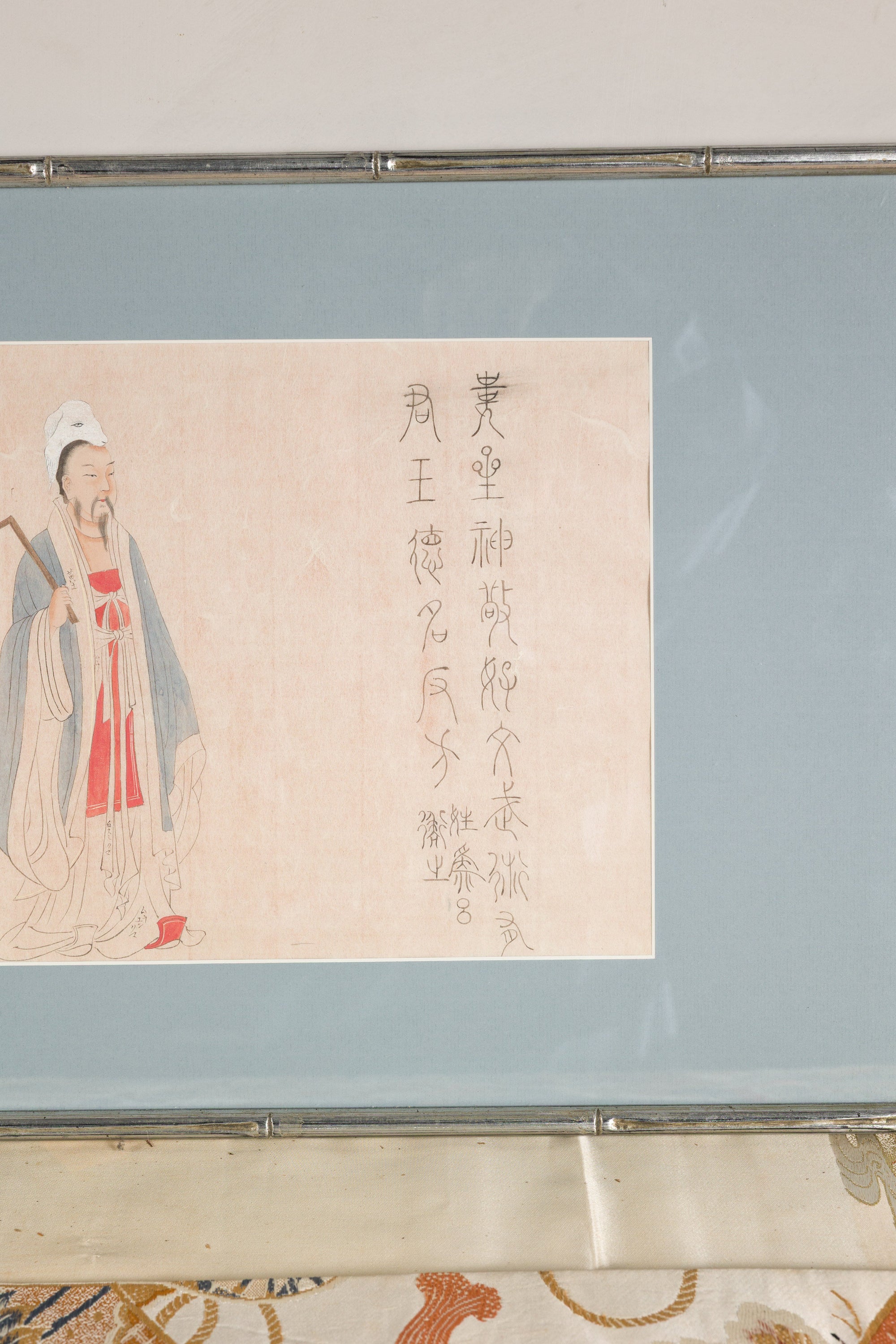 Lower detail of the standing figure print in its silvered frame