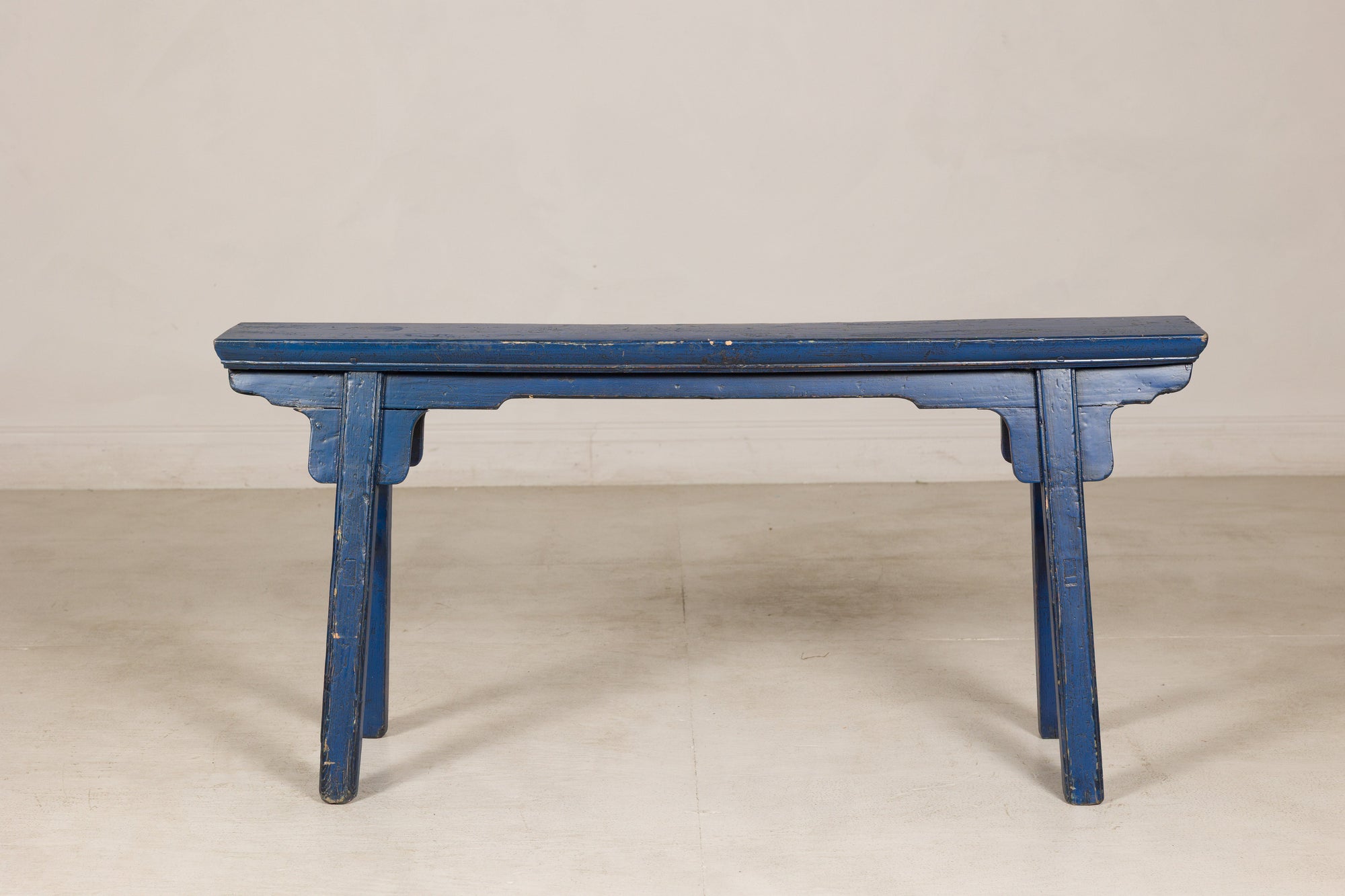 Blue painted wood narrow bench angled view