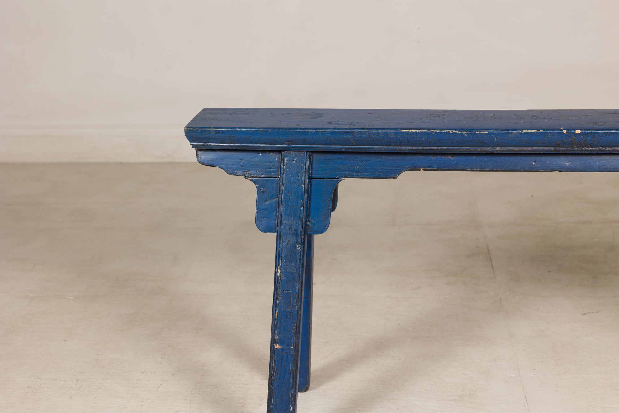 Blue painted wood narrow bench side view
