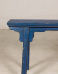Blue painted wood narrow bench side view
