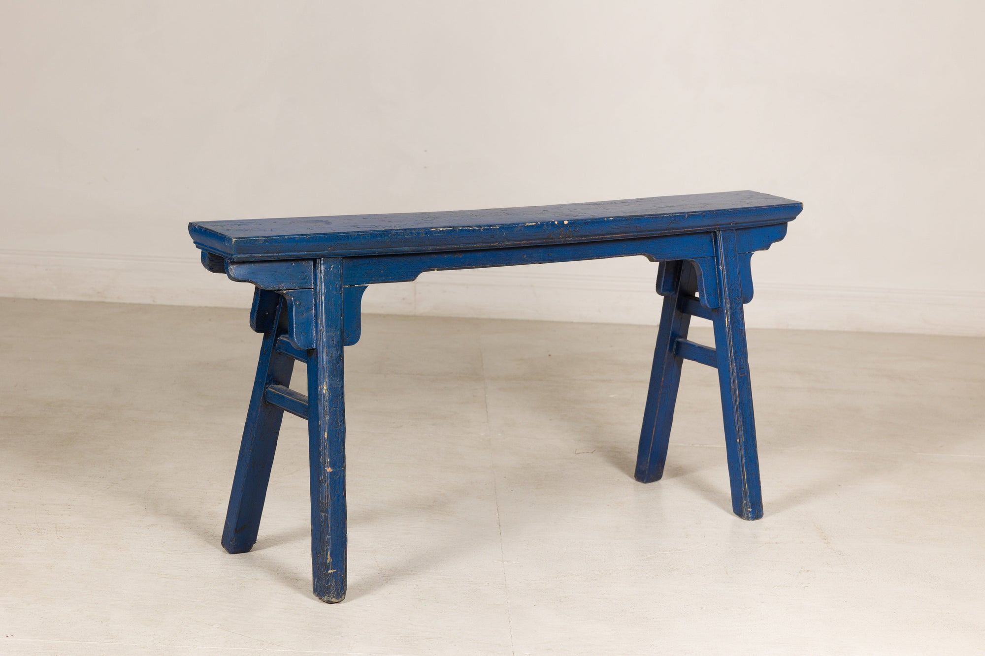 Blue painted wood narrow bench base view