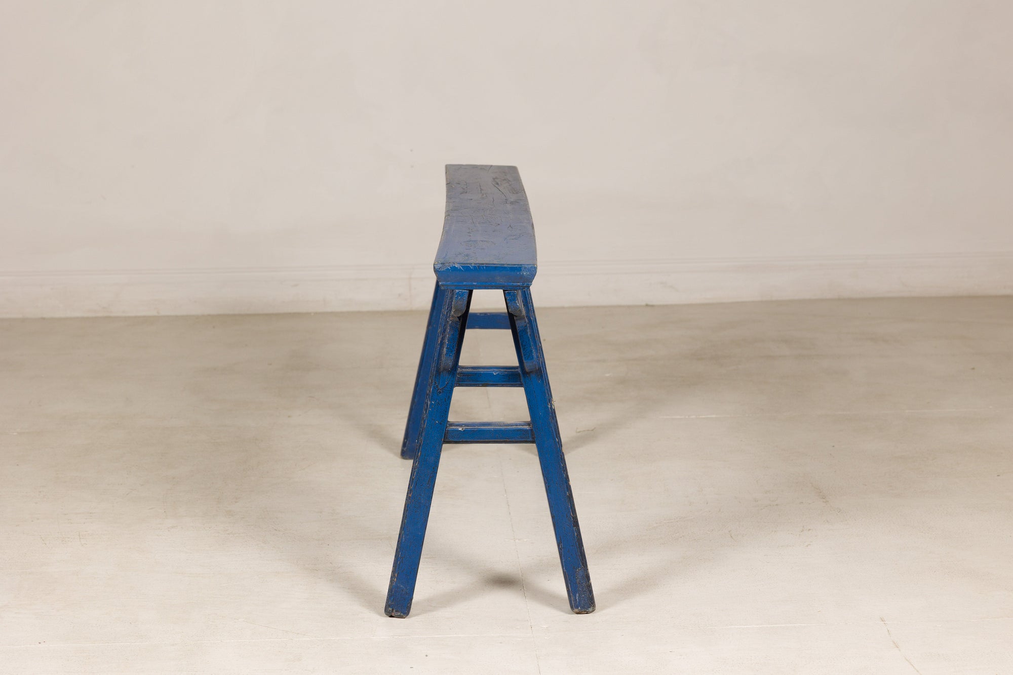 Blue painted wood narrow bench surface detail