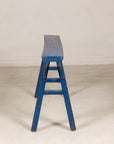 Blue painted wood narrow bench surface detail