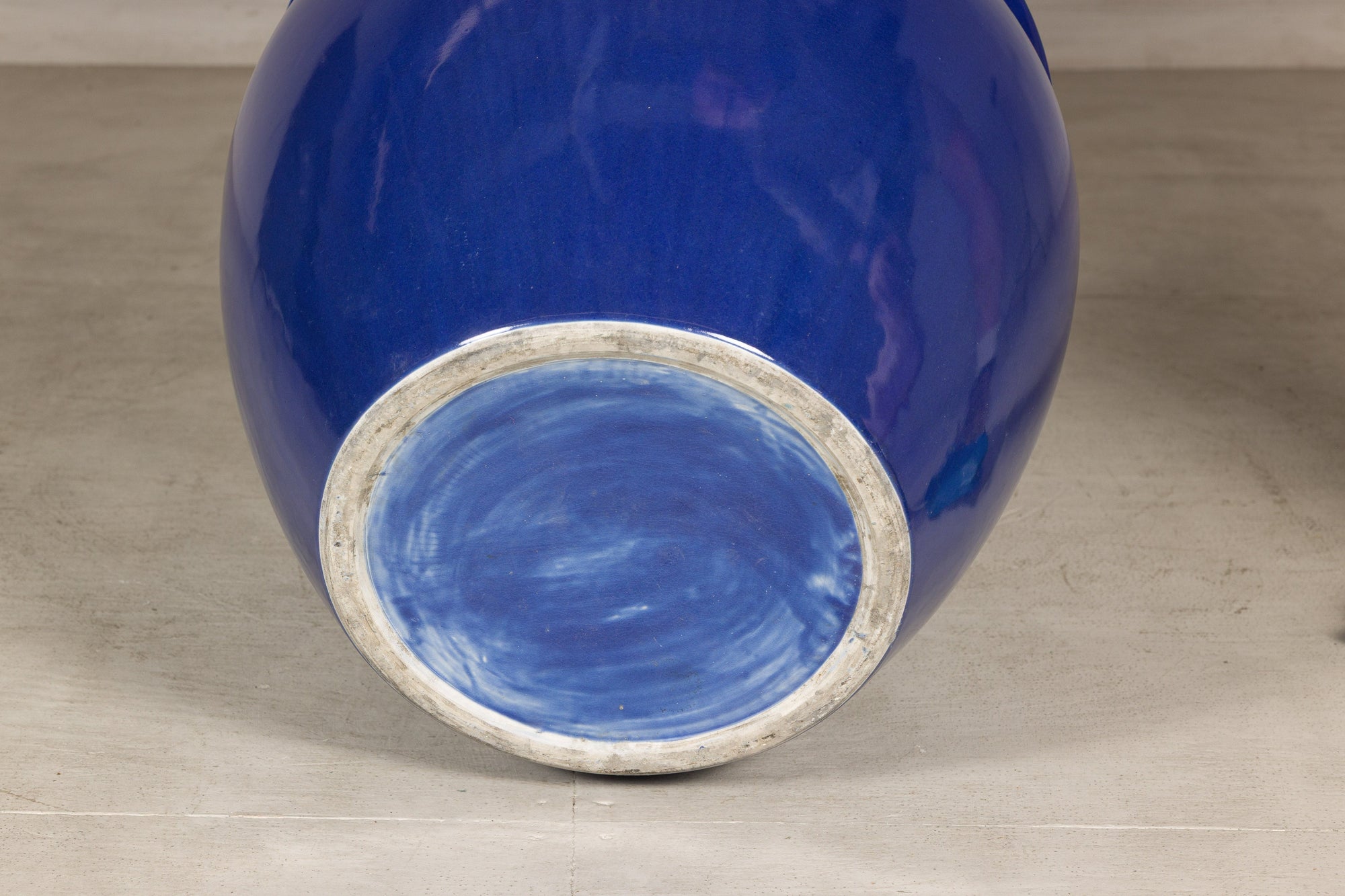 Bottom view showing the unglazed foot of the cobalt blue ceramic planter