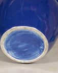 Bottom view showing the unglazed foot of the cobalt blue ceramic planter