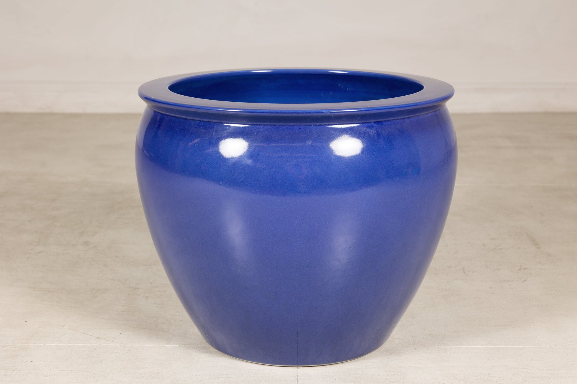Close front view of the rounded cobalt blue planter and rolled rim