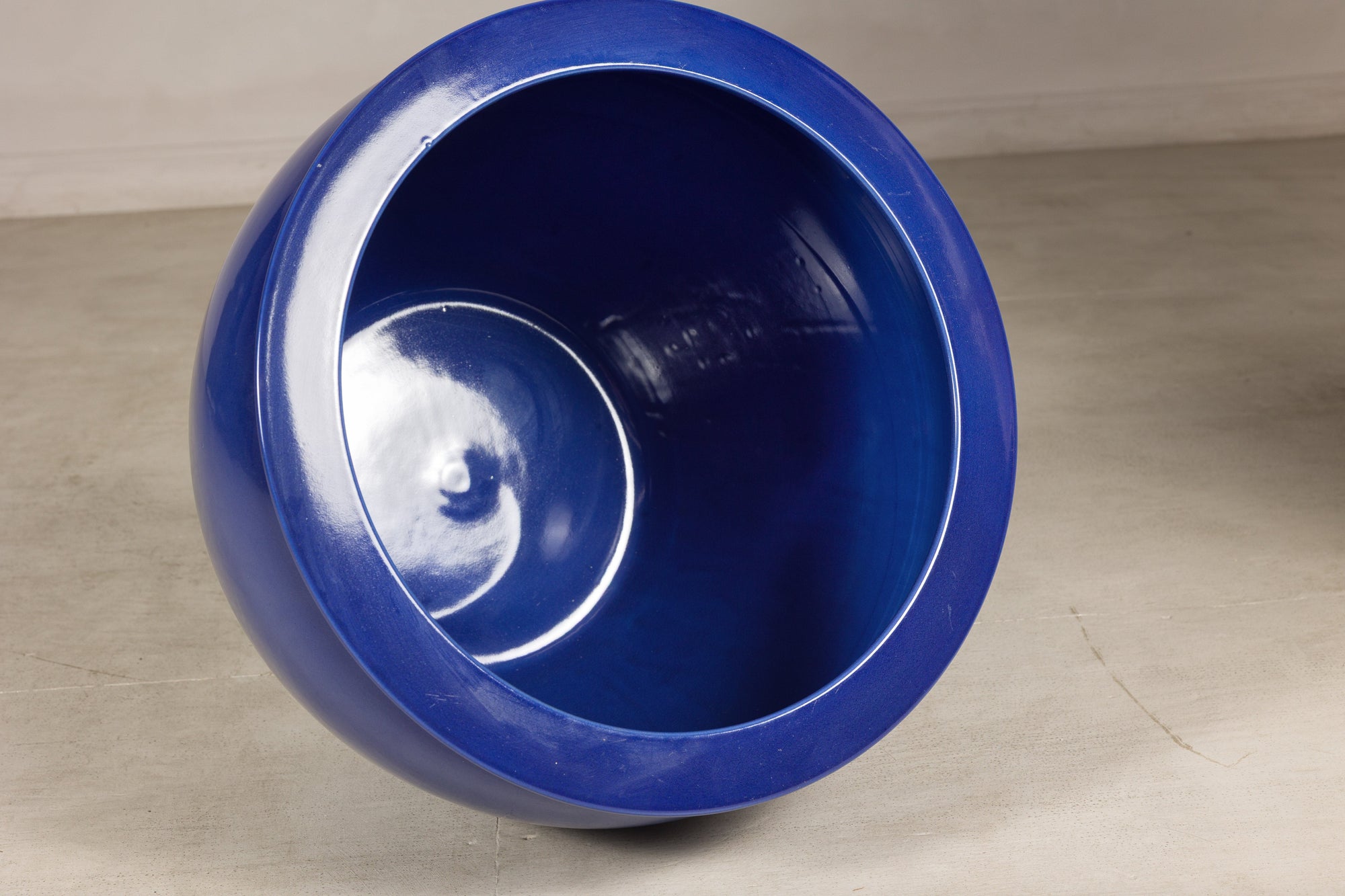 Angled view of the cobalt blue planter interior and wide rolled rim