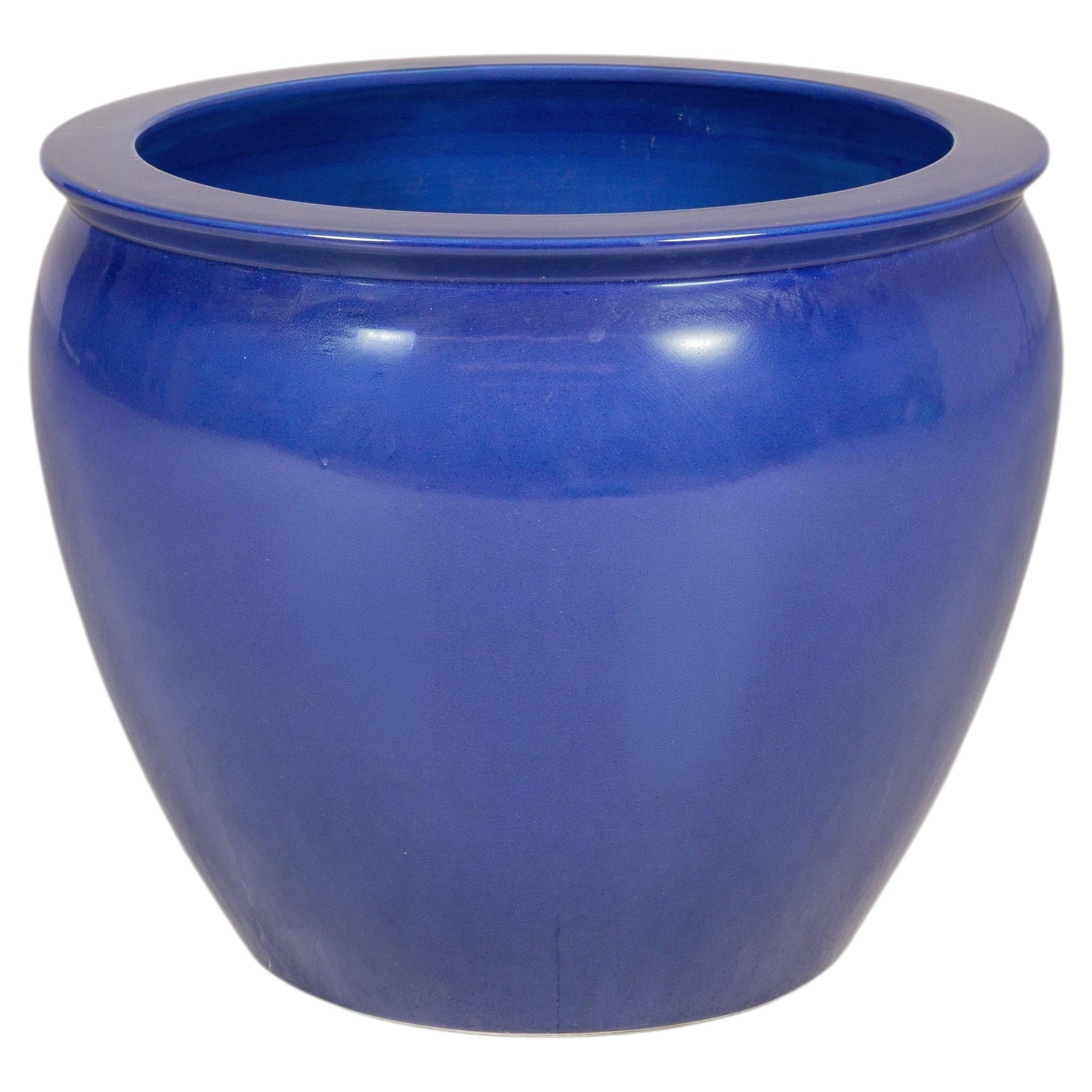 Cobalt blue glazed ceramic planter on a white background
