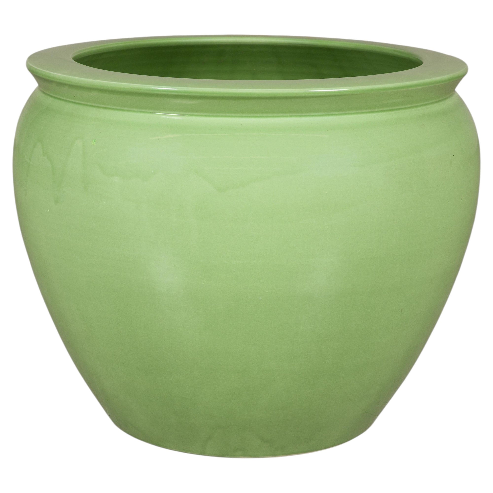 Apple green glazed ceramic planter on white background
