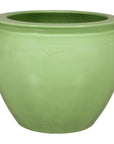 Apple green glazed ceramic planter on white background