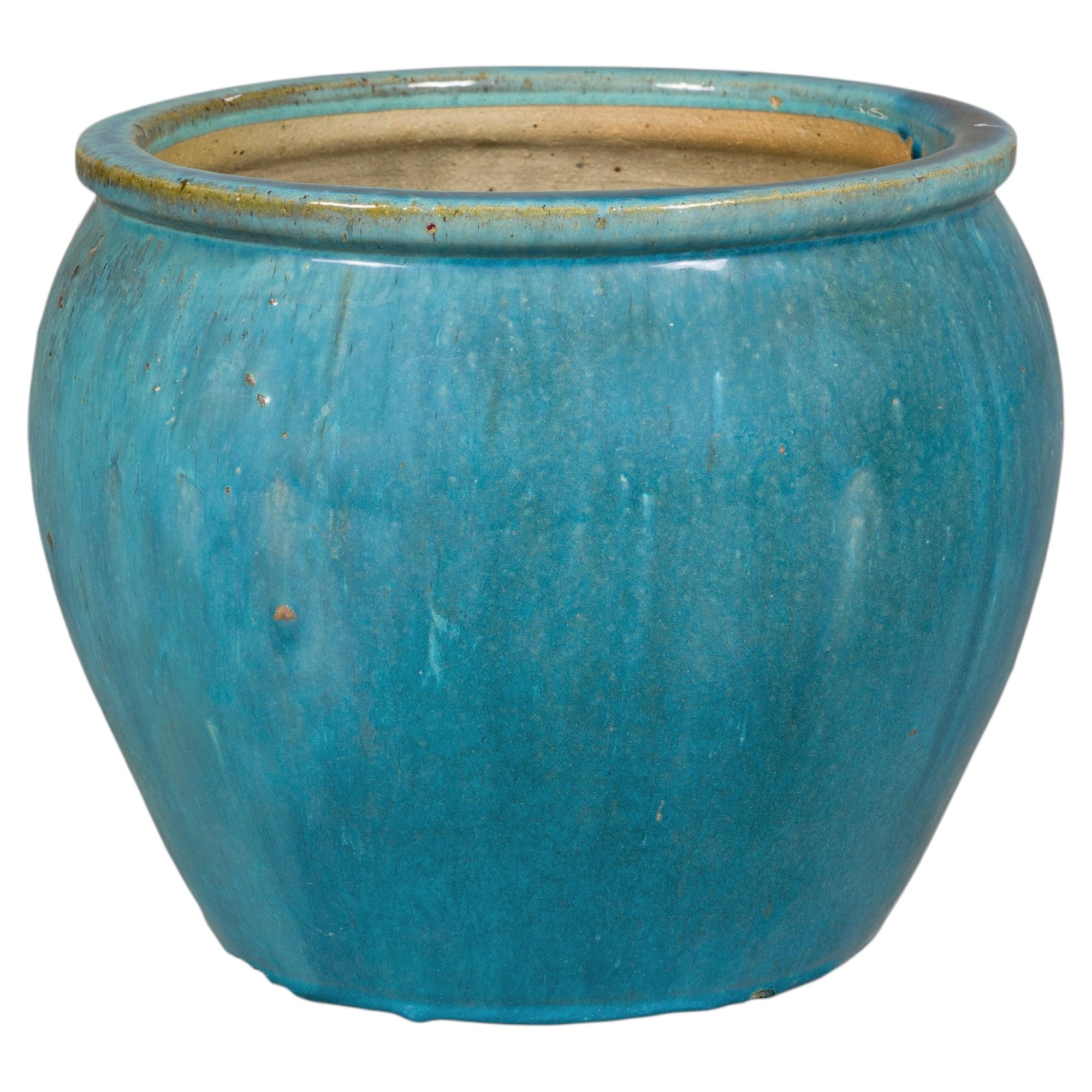 Turquoise glazed stoneware planter on white background