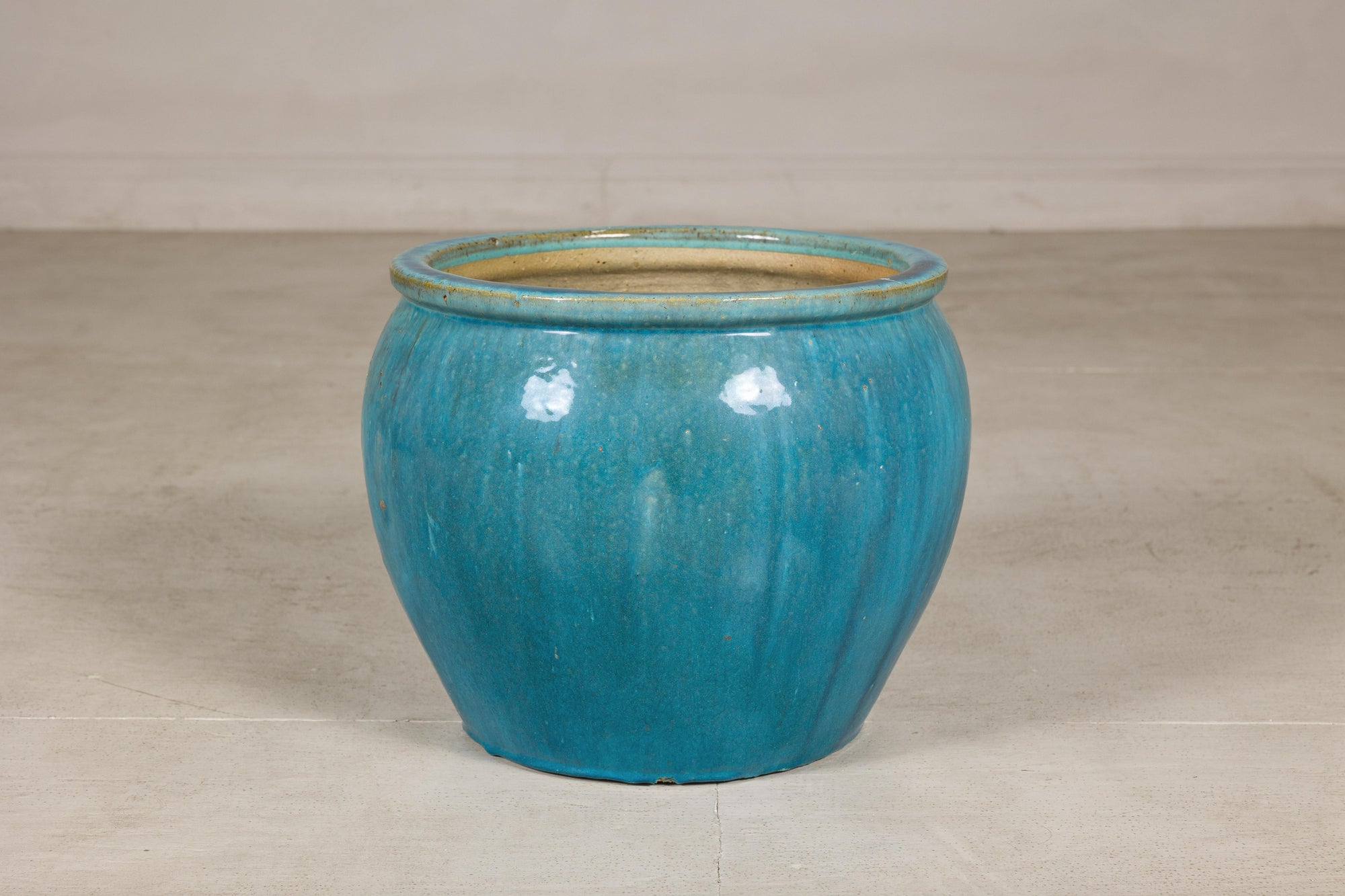 Turquoise glazed stoneware planter base view