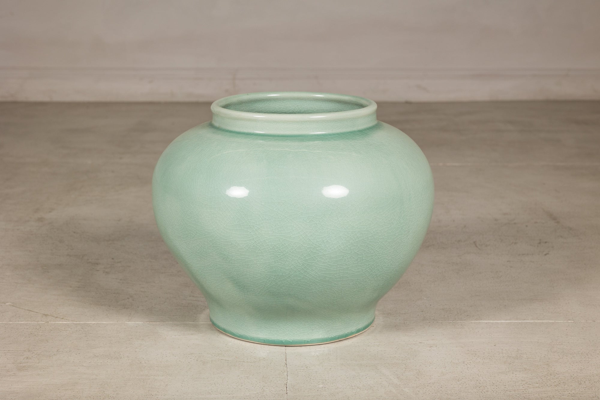 Alternate angled view of the rounded celadon ginger jar form vase