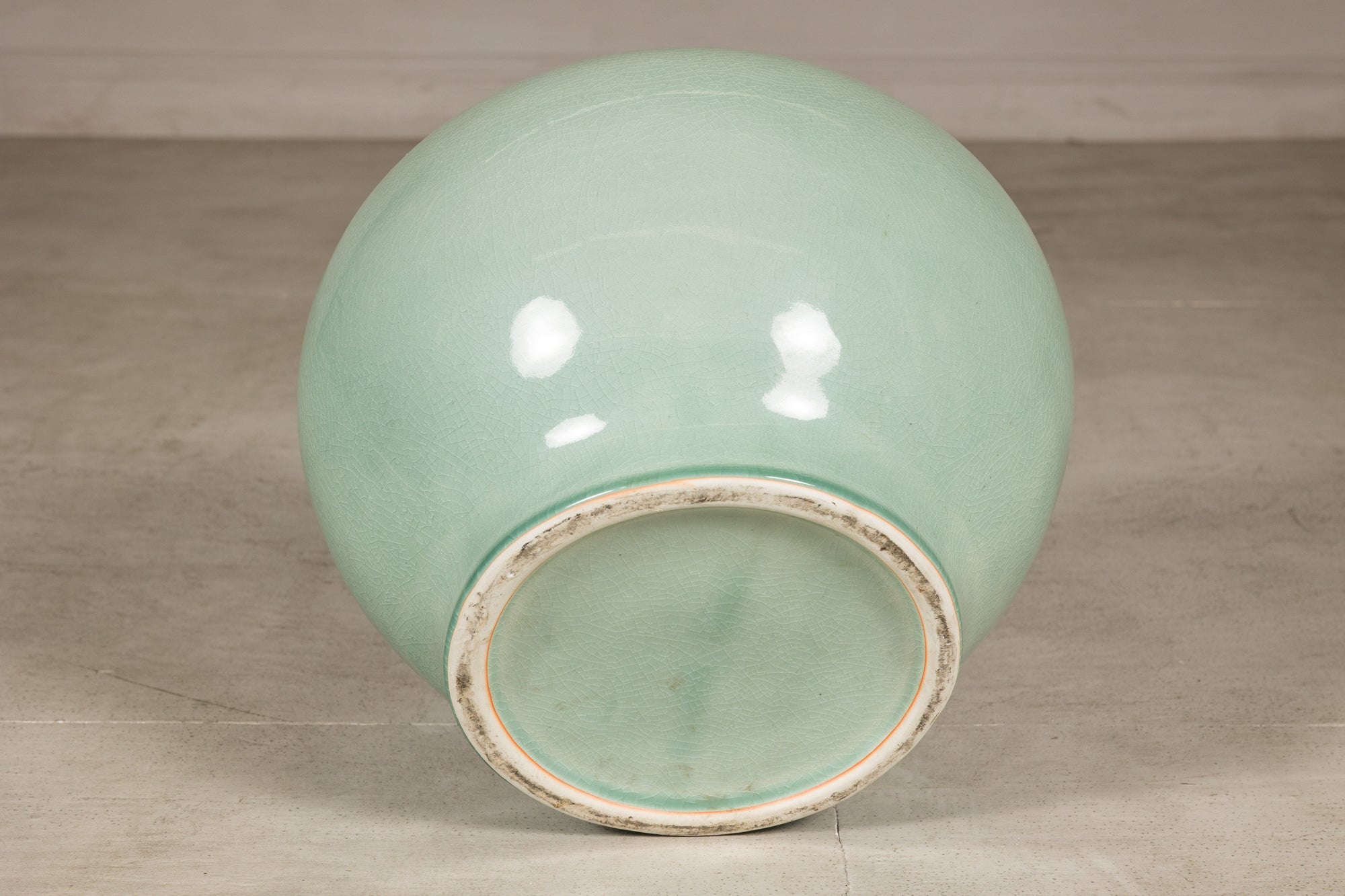Bottom view showing the recessed foot of the celadon ceramic vase