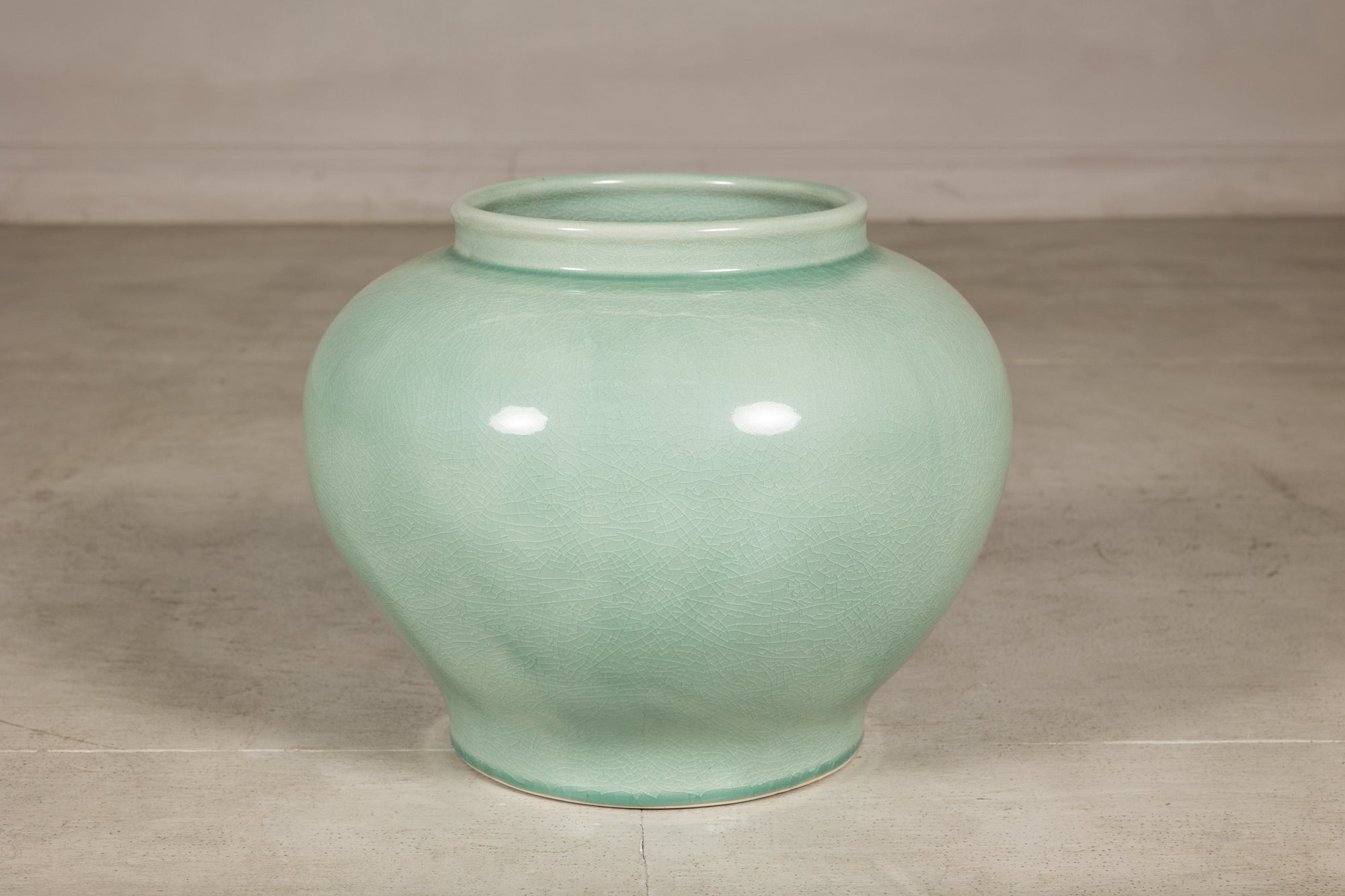 Front view of the rounded celadon ginger jar form vase