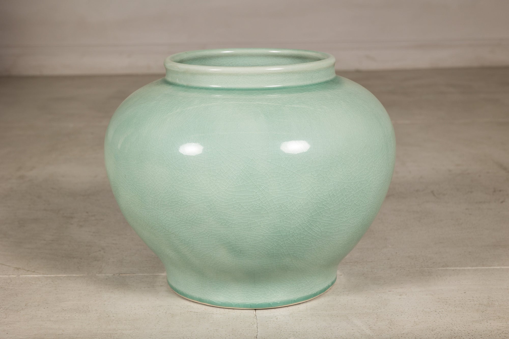 Left side view of the rounded celadon ginger jar form vase