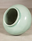 Angled view into the open mouth of the celadon ceramic vase