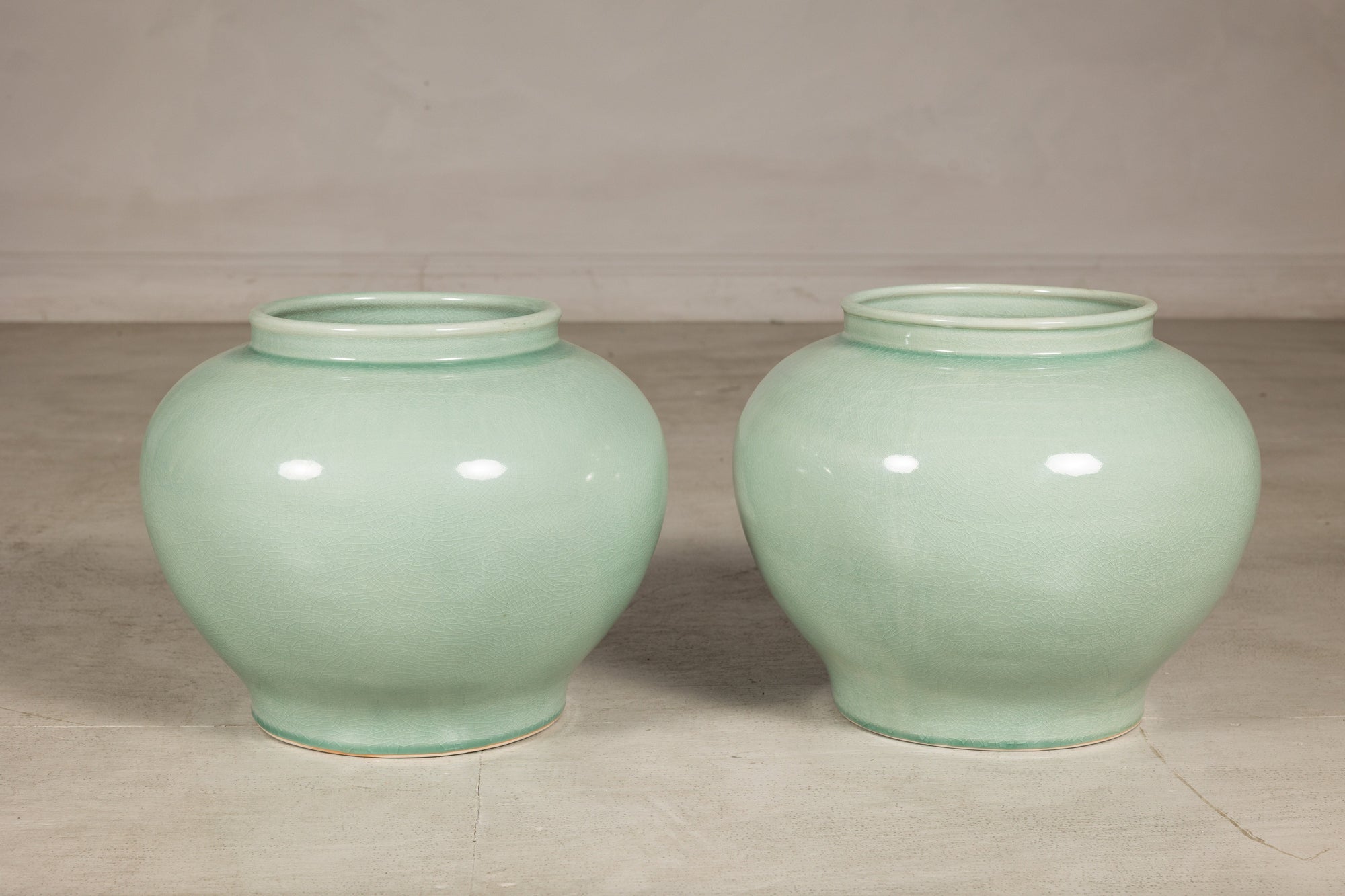Two celadon ginger jar form vases shown together for scale
