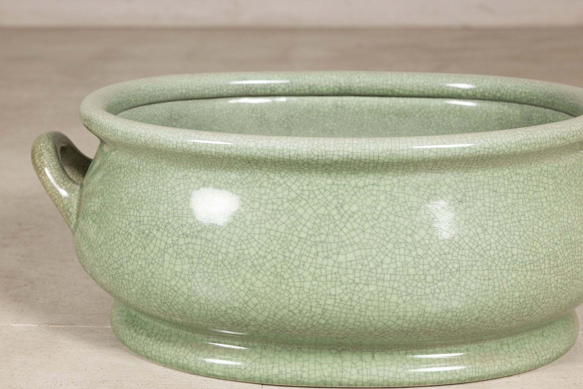 Close-up of the pale celadon crackle glaze and rounded body