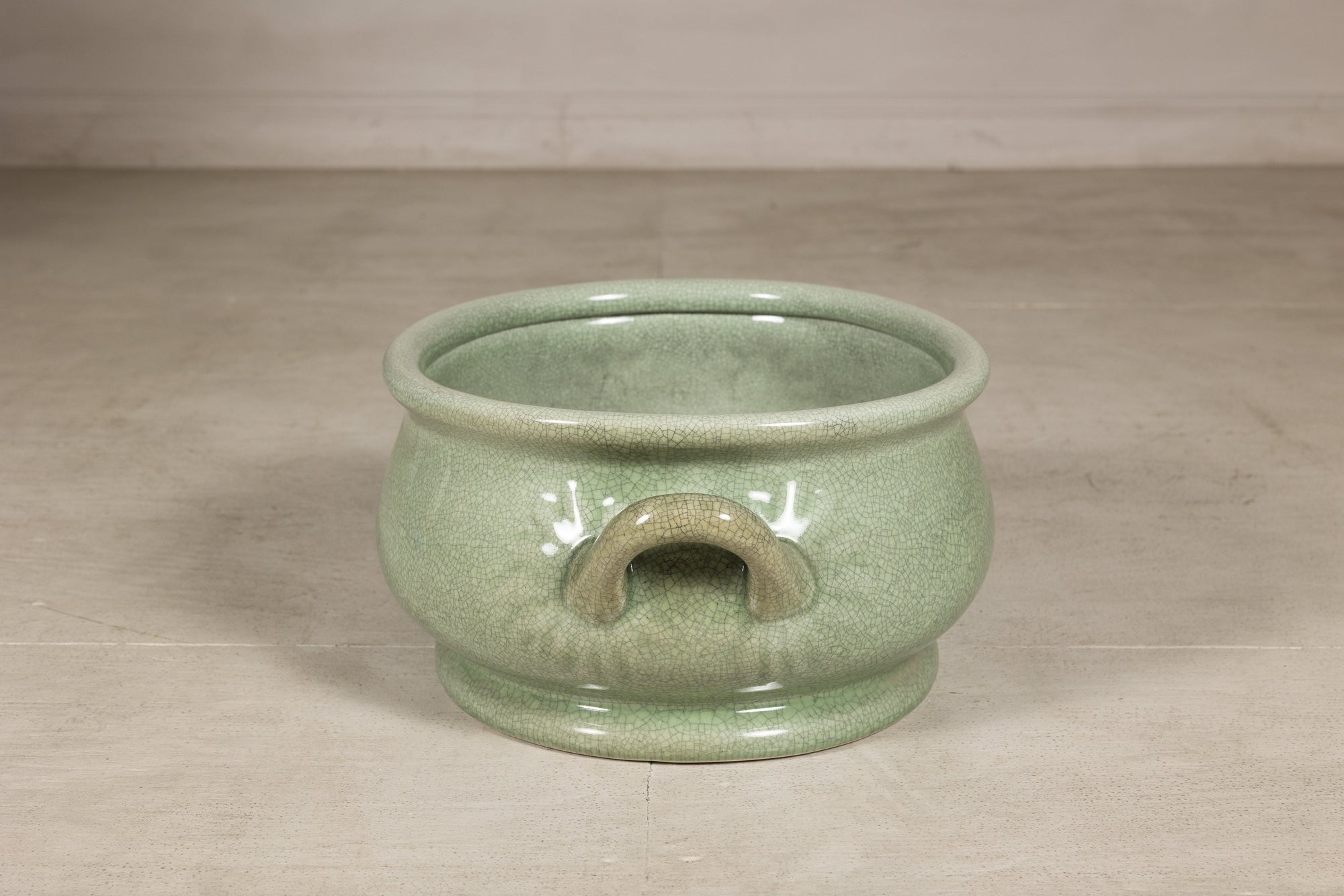 View centered on a loop handle and crackle glazed body
