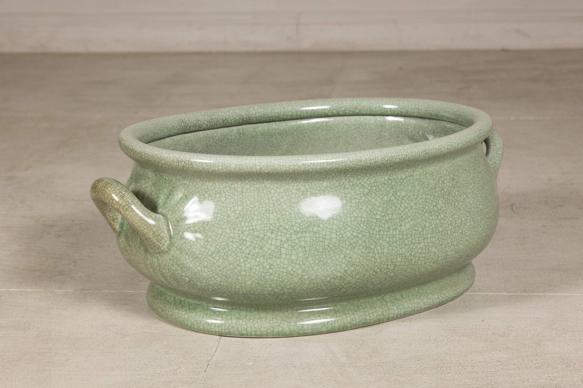 Left angled view of the oval celadon ceramic footbath