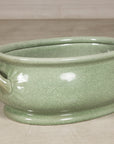 Left angled view of the oval celadon ceramic footbath
