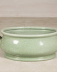 Side view of the celadon footbath with both loop handles visible