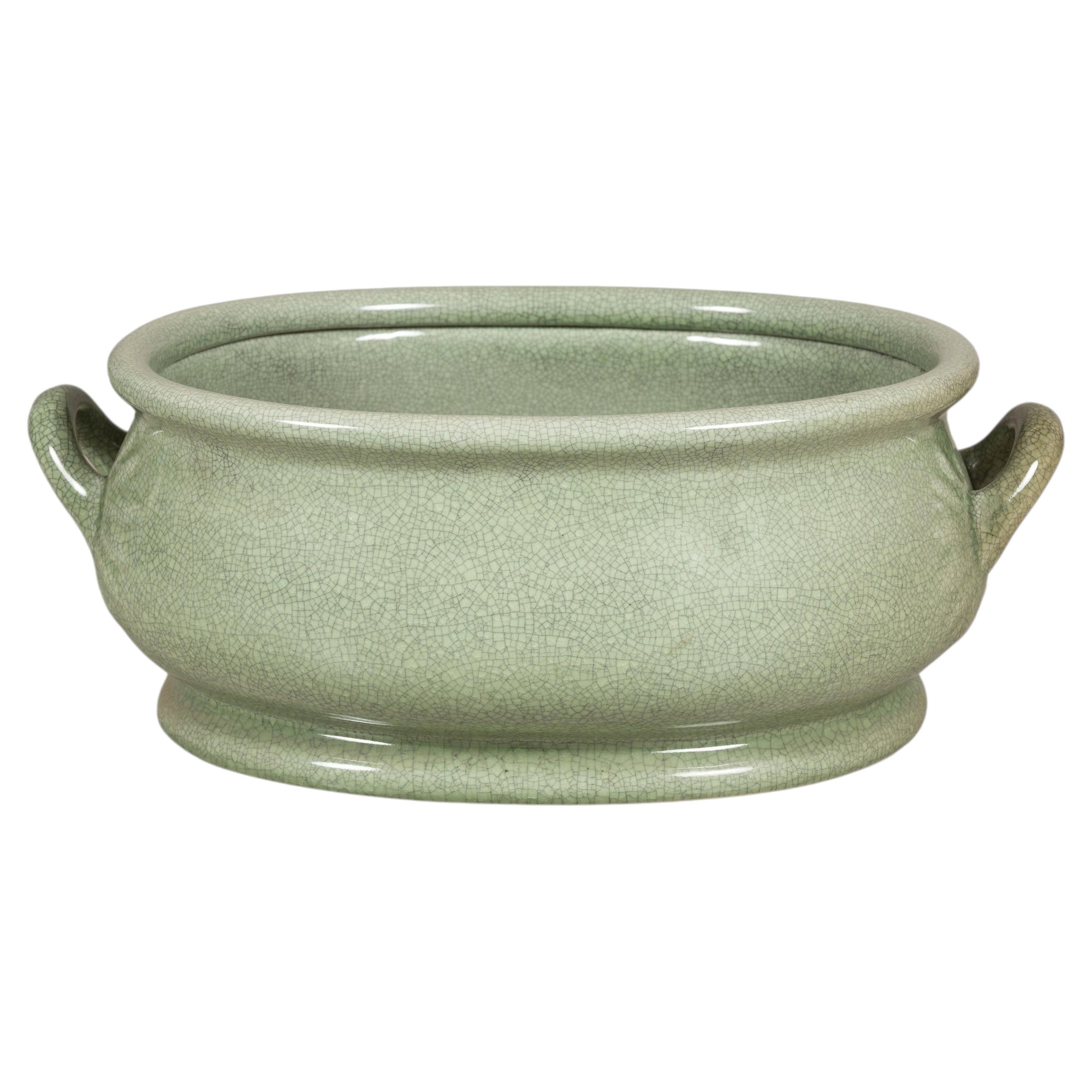 Celadon crackle glaze ceramic footbath with loop handles on a white background