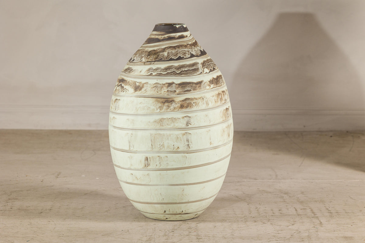 Cream marbled ceramic vase with brown bands.