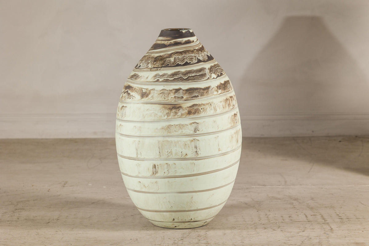 Large cream-glazed ceramic vase with horizontal brown swirled bands.